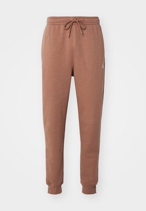 Bruine joggerbroeken van een zachte jersey stof. Voorzien van een elastische tailleband met een trekkoord en boorden bij de enkels. Witte logo-accent.