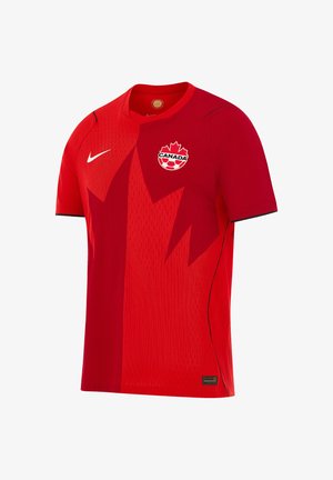 Czerwona koszulka piłkarska Kanady z ciemnym wzorem liścia klonu, logo Nike na prawej piersi i emblematem Kanadyjskiego futbolu na lewej piersi.