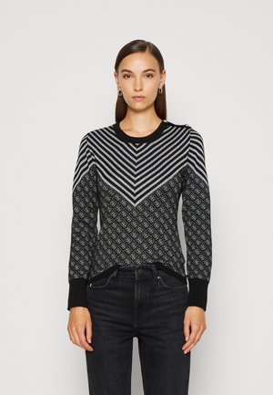 Maglione bianco e nero con un motivo a zigzag e accenti a diamante. Caratterizzato da un collo rotondo e polsini a coste. Orlo di un colore solido.