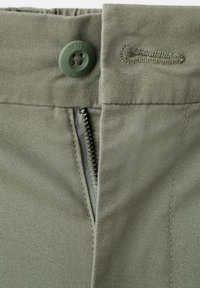 Green cotton pants featuring a zip and button closure. The fabric has a smooth texture with subtly stitched details around the waistband.