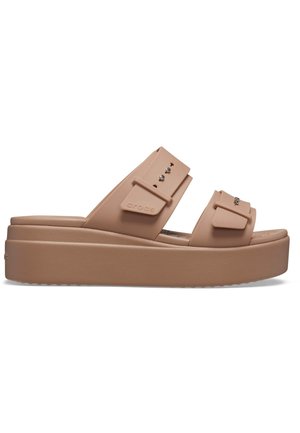 Light brown platform sandals made of rubber material, featuring two wide straps, adjustable buckles, and subtle decorative accents.