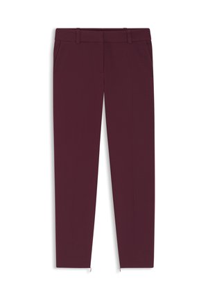 Burgundy tailored pants with a smooth fabric, slim fit, two side pockets, and zips at the ankle for added detail.