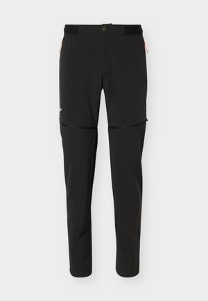 Pantalones de senderismo convertibles negros con piernas desmontables con cremallera, cierre con botón y cremallera, y bolsillos laterales con cremallera.