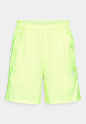 Neon-gelbe Sports shorts aus glattem, leichtem Material mit elastischem Bund und seitlichen Reißverschlusstaschen.
