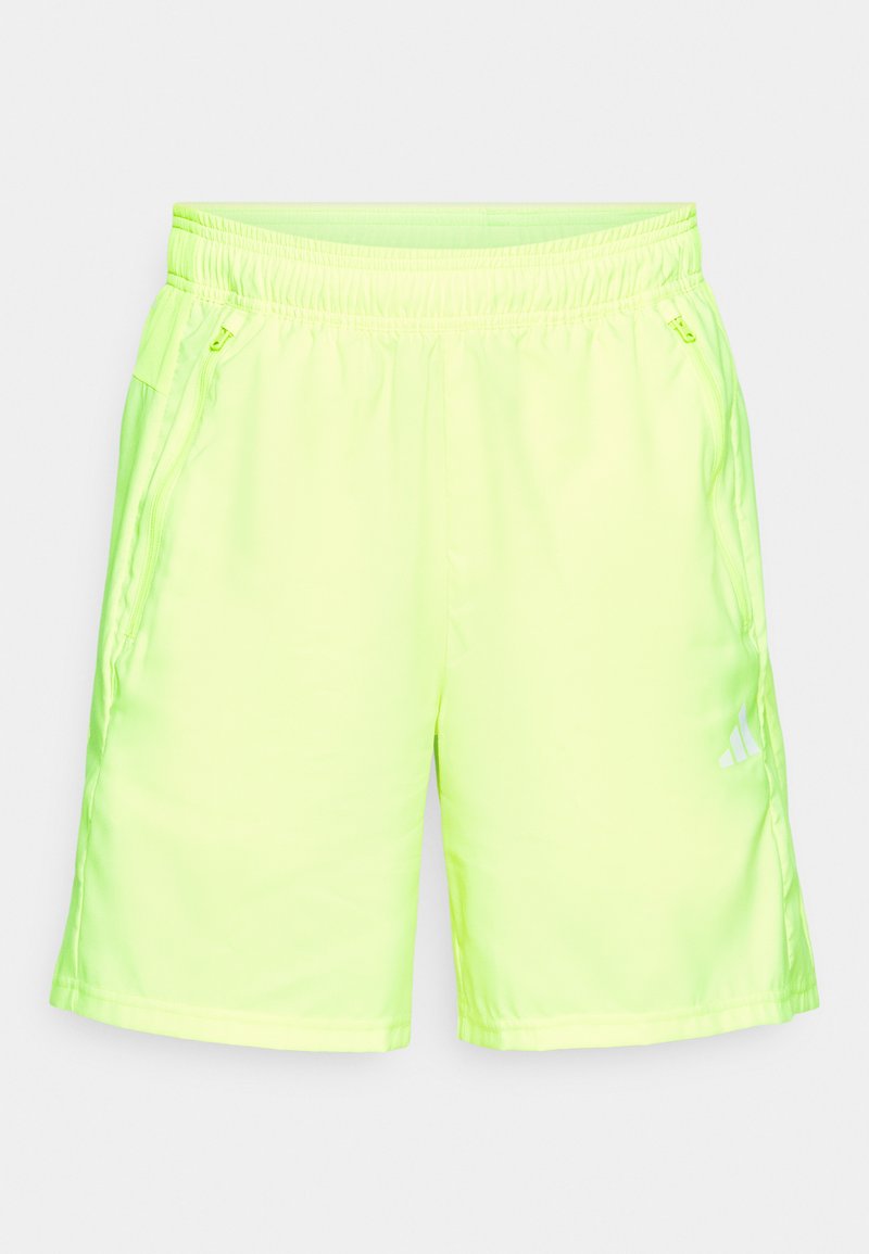 Pantaloni sportivi giallo neon realizzati in un tessuto liscio e leggero, con una vita elasticizzata e tasche laterali con zip.