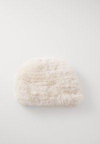 Cream-colored fuzzy clutch bag with gold "Guess" logo on a light background.
