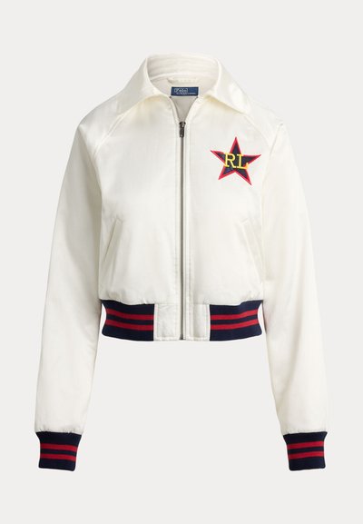 White zip-up bomber jacket with red and navy striped ribbed cuffs and hem, featuring a red star patch with yellow "RL" letters on the chest.