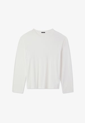 Maglietta bianca a maniche lunghe in materiale a coste. Presenta un collo a giro e un taglio corto, offrendo una texture liscia e un design semplice.