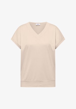 Haut beige à manches courtes avec col en V et manches retroussées, présentant un ourlet droit et une texture de tissu lisse.