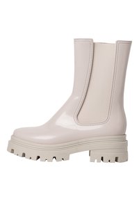 Bottine glossy rose clair avec des panneaux élastiques sur les côtés, semelle en caoutchouc gris robuste et semelle texturée pour une meilleure adhérence. Design épuré et minimaliste.