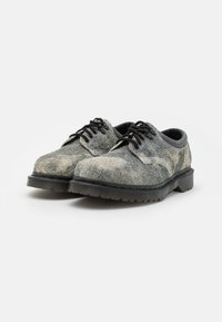 Sznurowane buty wykonane z teksturowanej szaro-czarnej tkaniny, z grubą czarną gumową podeszwą z rowkowanymi detalami dla lepszej przyczepności.
