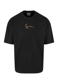 Camiseta negra de manga corta con cuello redondo y pequeño logo dorado en cursiva "Kane" centrado en el pecho.