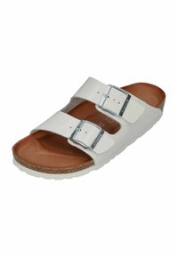 White two-strap sandal with adjustable silver buckles, cork footbed, and rubber sole. Smooth, glossy material with a brown inner lining.