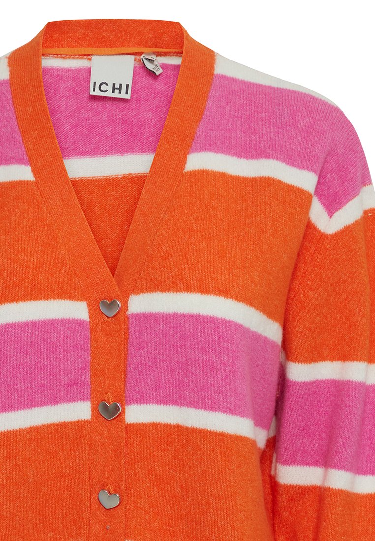 Pasiasty kardigan w kolorach pomarańczowym, różowym i białym. Posiada dekolt w serek, guziki w kształcie serca oraz miękką teksturę.