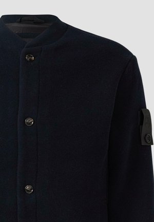 Marineblaue Wolljacke mit hohem Kragen, ausgestattet mit schwarzen Knöpfen und einem geprägten Logo am linken Ärmel. Glatte Textur und taillierte Passform.