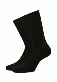 Czarne skarpetki crew wykonane z gładkiego materiału. Posiadają ribbowany krój na górze oraz bezszwowy palec dla wygody. Prosty, jednolity design bez wzorów.