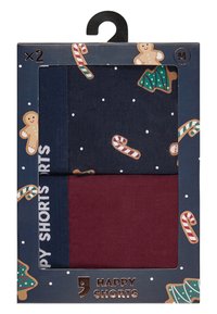 Tweepack shorts in marineblauw met witte stippen en bordeauxrood. Doos is voorzien van patronen van peperkoek en zuurstokken op een donkere achtergrond.