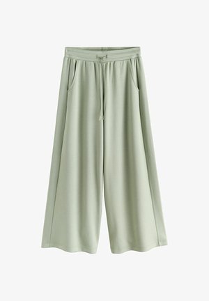 Gaiši zaļas plataji bikses ar elastīgu jostu un auklu, priekšējās kabatas, izgatavotas no mīksta, plūstoša auduma.