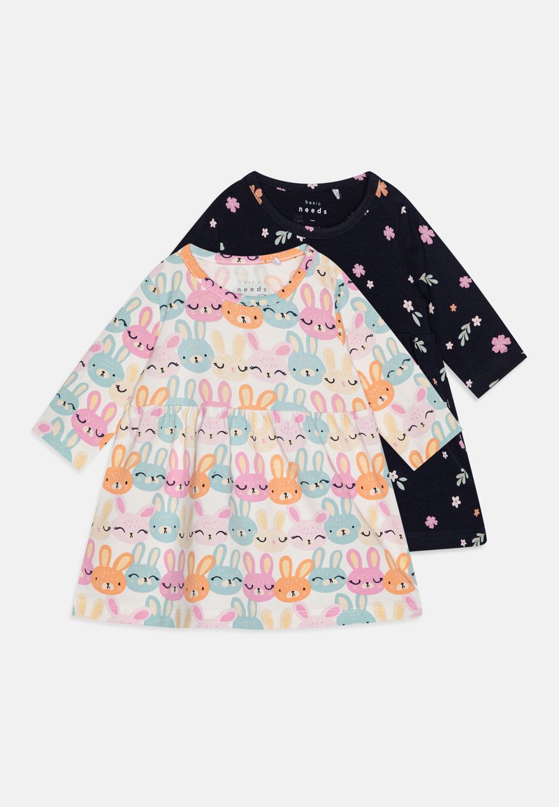 Two long-sleeve dresses: one features a light background with colorful bunny prints, the other is navy with floral patterns. Both made of cotton.