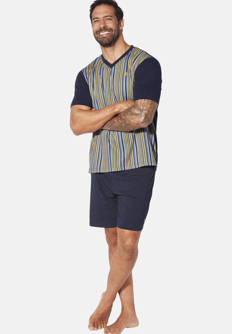 Men's loungewear set consisting of a navy short-sleeve V-neck top with multicolored vertical stripes and matching navy shorts.
