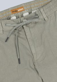 Grey cotton shorts with an elastic waistband, drawstring closure, and side pockets. Features a textured fabric and contrast stitching.