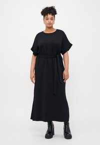 Black maxi dress with short sleeves, featuring a round neckline and a fabric belt at the waist. Smooth texture with a relaxed fit.