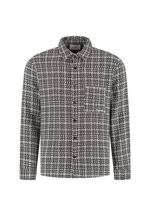 Een knoopshirt in zwart-wit tweedpatroon, met lange mouwen, een kraag en een borstzakje met bruine knopen.