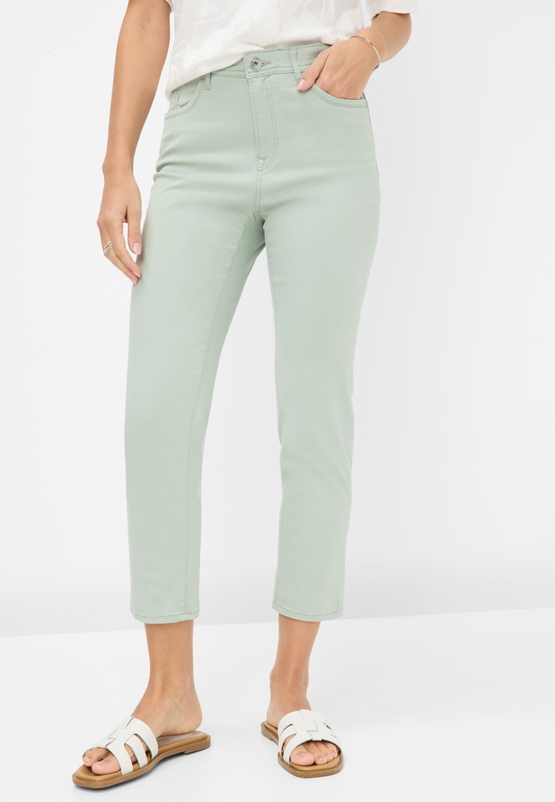 Hellgrüne, hochtaillierte Jeans mit schmaler Passform und verkürzter Länge. Strukturierter Baumwollstoff mit klassischem Fünf-Taschen-Design.