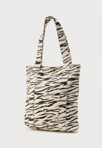 Τσάντα καμβά σε κρεμ απόχρωση με μοτίβο μαύρης ρίγας τίγρης, με δύο ανθεκτικές λαβές και τετράγωνο σχήμα. Κατασκευή από υφή υφάσματος.