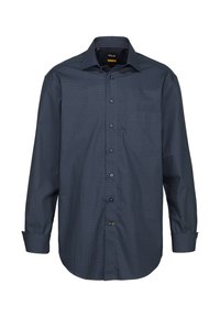 Camicia button-up a maniche lunghe di colore blu navy scuro con motivo geometrico bianco. Presenta una tasca sul petto, colletto classico e polsini regolabili con bottoni.