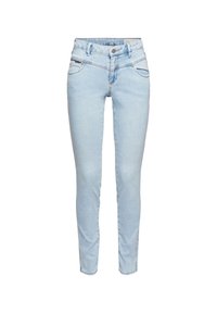 Jeans ajustados de color azul claro con botón frontal, bolsillos con cremallera y pasadores para cinturón, exhibidos sobre un fondo blanco.