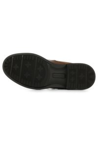 Scarpa in pelle marrone con suola in gomma nera testurizzata, dotata di battistrada decorato e dettagli sul tallone per garantire durata e aderenza.