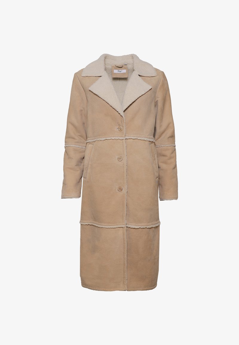 Beige shearling-takki, jossa on lovettu kaulus, nappisulku, sivutaskut ja teksturoitu viimeistely, kontrastina vaaleammasta fleecevuoresta.