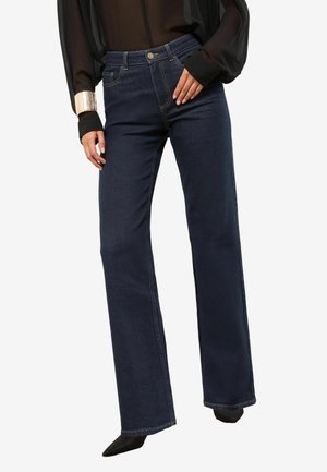 Dunkelblaue Schlagjeans aus Denim; mit Fronttaschen, Knopfverschluss und klassischem Fünf-Taschen-Design. Weiche Textur.