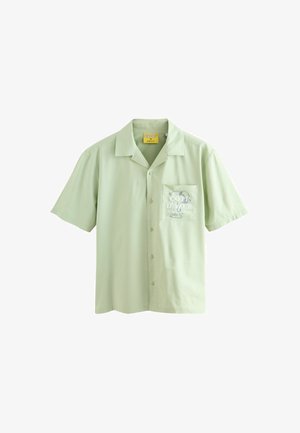 Short-sleeve button-up shirt in light green fabric, featuring a chest pocket with a Snoopy graphic and text "COTE D'AZUR" in white.