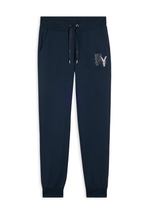 Pantaloni della tuta blu navy realizzati in tessuto morbido, dotati di vita elastica con cordini, tasche laterali e un logo decorativo in strass.