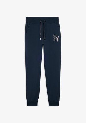 Pantaloni della tuta blu navy realizzati in tessuto morbido, dotati di vita elastica con cordini, tasche laterali e un logo decorativo in strass.