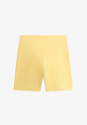 Keltainen urheilushortsit, joissa on korkea vyötärö, sileä pinta ja tiukka muotoilu. Ominaisuuksina saumaton etuosa ja sivupaneelien yksityiskohdat.