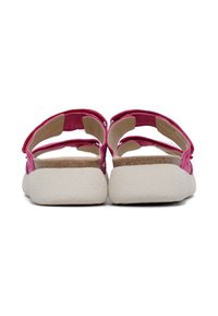Sandal rosa con una soletta in sughero testurizzato, suola in gomma bianca e cinturini regolabili. Parte posteriore aperta con dettagli minimi per comfort e vestibilità.