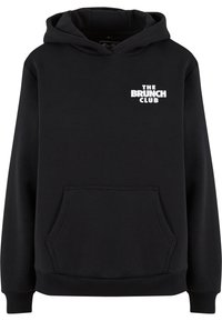 Black hoodie made of soft fabric features a front kangaroo pocket and a white graphic text "THE BRUNCH CLUB" on the chest.