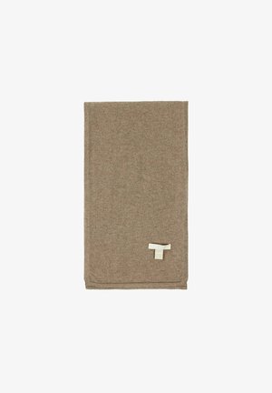 Braune Wollwurfdecke, weiche Textur, rechteckige Form, mit einem weißen Etikett mit dem Markennamen, das in der unteren Ecke angenäht ist.