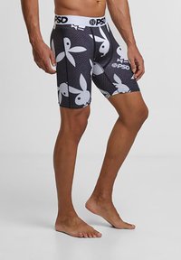 Boxers noirs avec des logos de lapin Playboy blancs. Présentent un design ajusté, une ceinture élastique avec le nom de la marque et un tissu lisse et extensible.