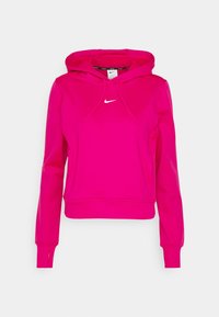 Haut à capuche rose vif, court, avec des manches longues, poche kangourou à l'avant, trous pour les pouces et petit logo Nike blanc sur la poitrine.