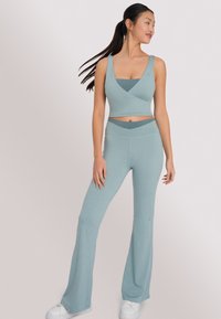 OCEANSAPART DAHLIA FLARED - Pantaloni - light aloe grey