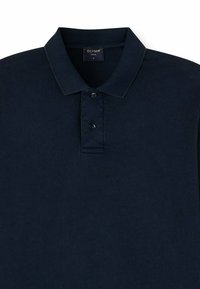 Navy blue polo shirt made of textured fabric, featuring a classic collar, three buttons, and a label indicating "OLYMP CASUAL" size M.