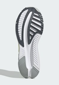 Suela de zapatilla de goma con una mezcla de colores blanco y gris, con patrones texturizados para agarre y flexibilidad, diseñada para tracción.