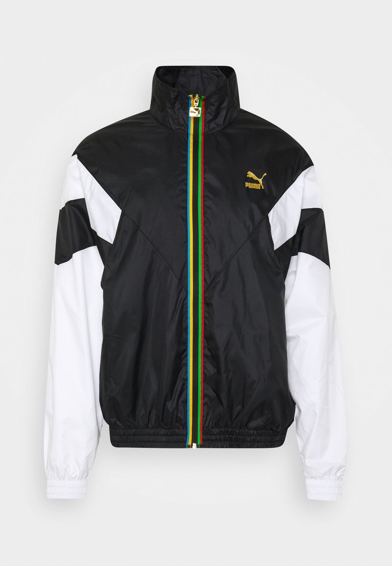 Black and white zip-up jacket with a high collar, featuring a multicolor stripe down the center and a Puma logo in gold.