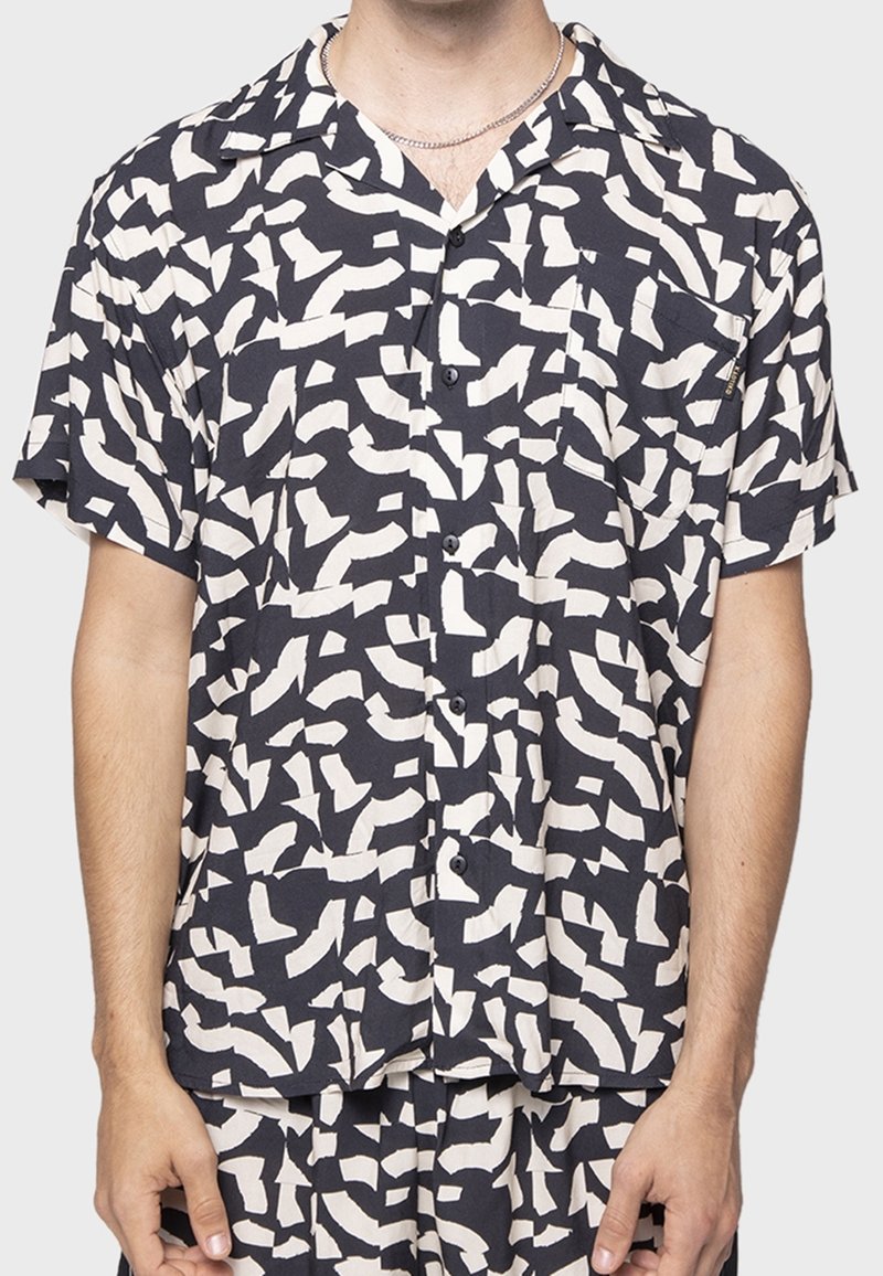Camicia a maniche corte con bottoni in navy con un grande motivo astratto color crema, realizzata in tessuto leggero. Presenta una tasca sul petto e un colletto.