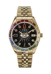 Ceas din metal cu ton de aur, cu un cadran negru, accente colorate din cristale și o brățară texturată. Prezintă un design unic în formă de ochi pe cadran.