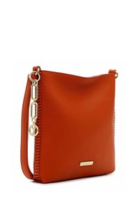 Orange leather crossbody bag with a smooth texture, gold hardware, and a braided accent on one side. Features a flat base for stability.